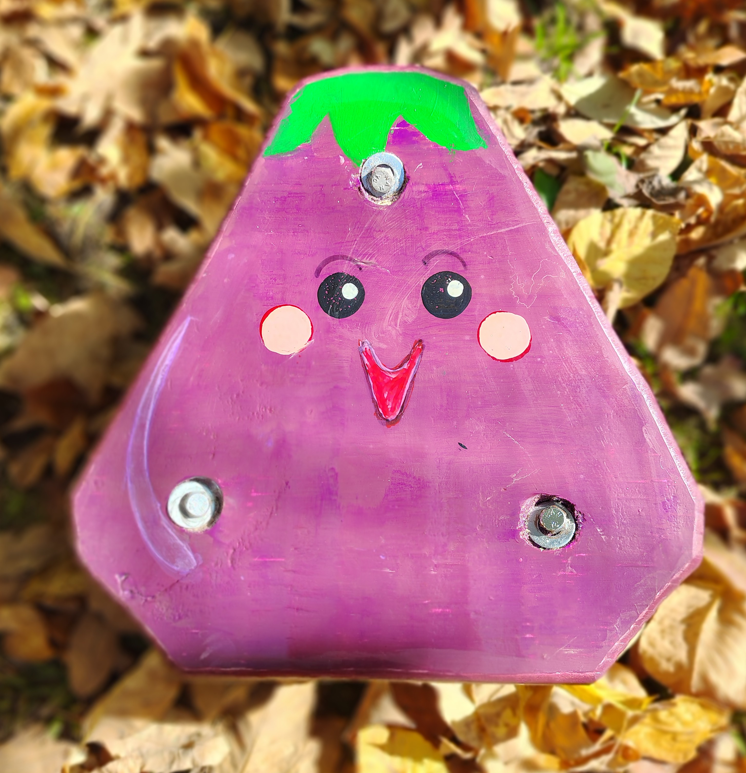 A small, handcrafted eggplant plush toy